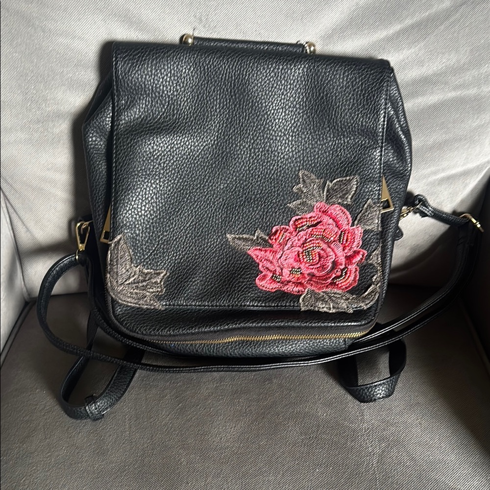 Black and Red Backpack with Adjustable Straps and Durable Design